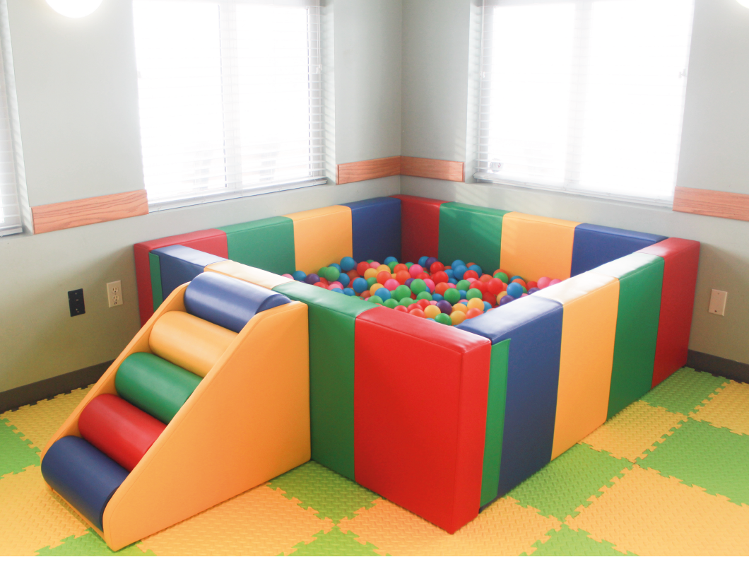 colourful ball pit. square. multi coloured step up. filled with multi colour balls