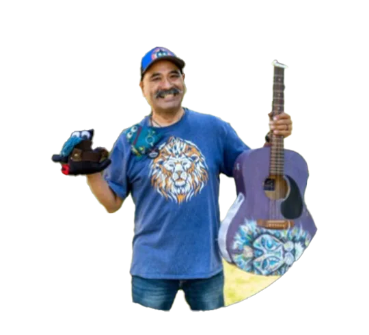 Smiling man in blue shirt holds a guitar and toy tools.